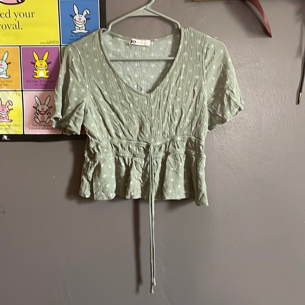 Light green shirt with strings.